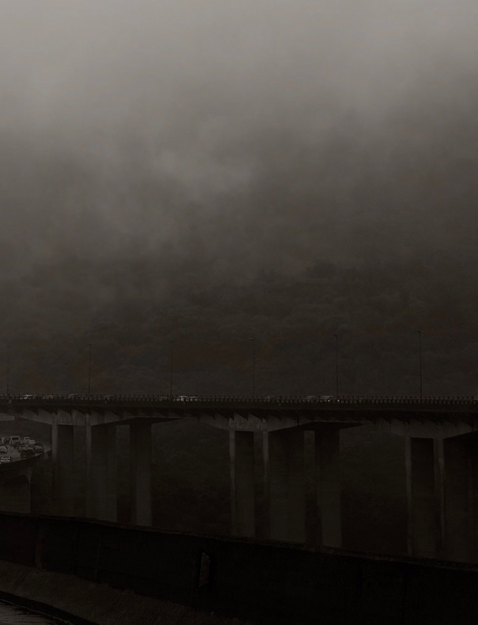 Bridge traffic disappearing into fog