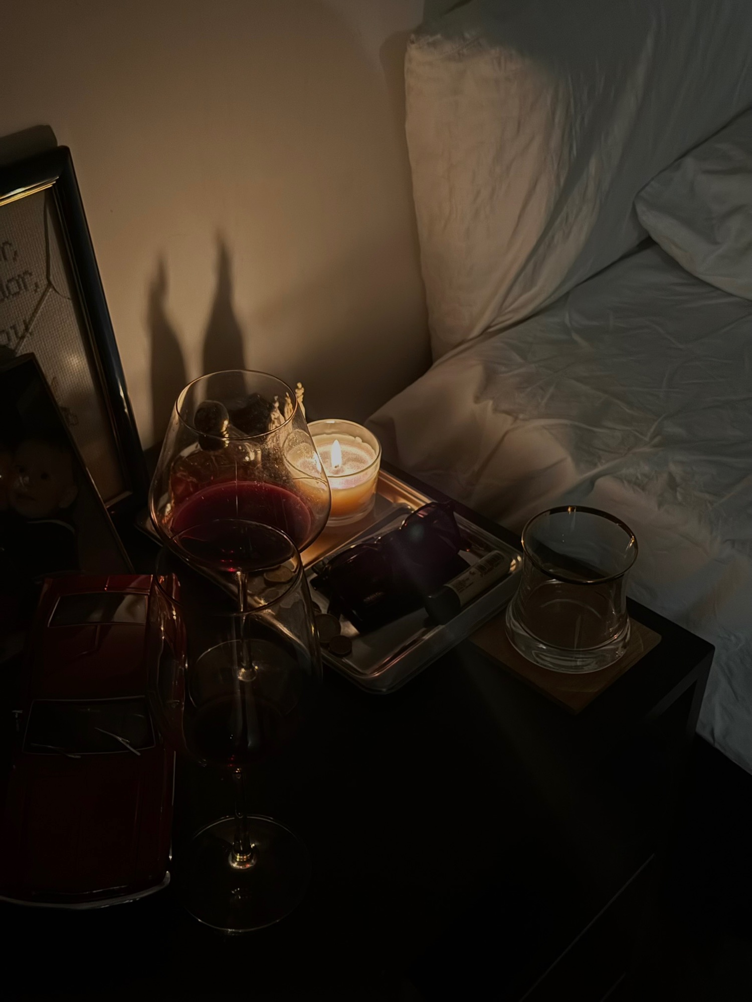 Candlelit nightstand with wine glasses